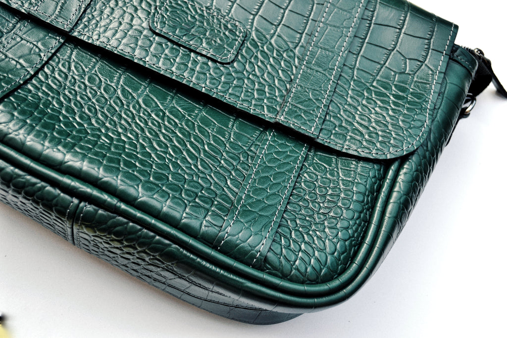 Green textured handbag on a white background