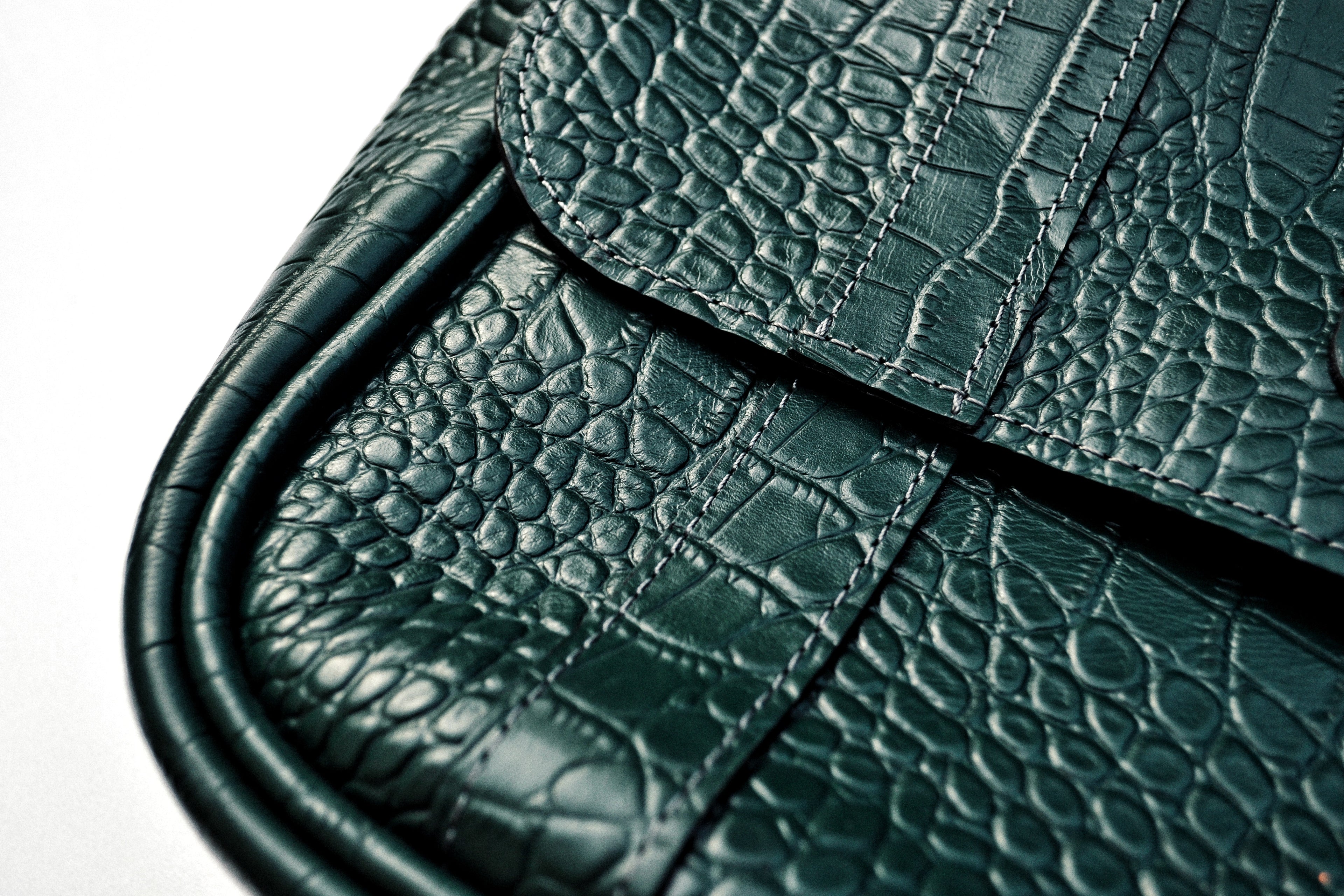 Close-up of a green textured messenger bag
