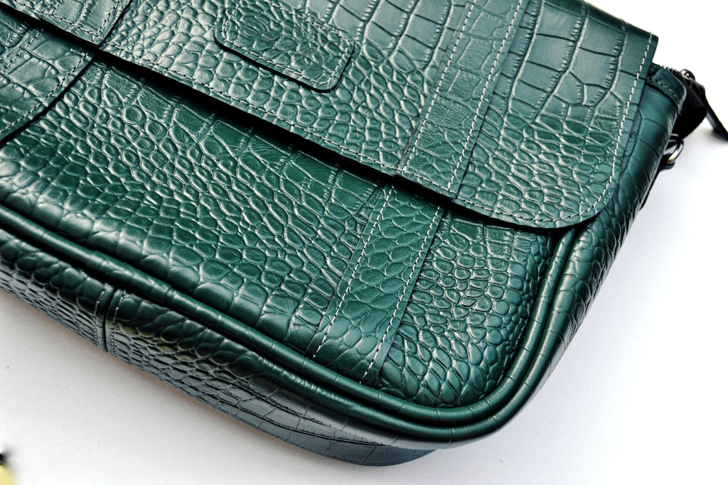 Green textured handbag on a white background